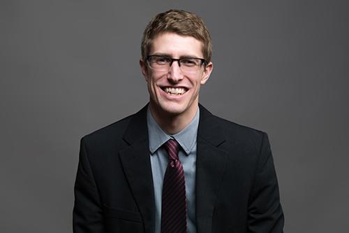 Smiling student in a suit and tie